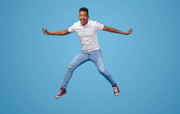 istock Funny black man jumping and looking at camera 1161476424