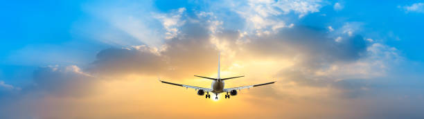 istock Airplane in the sky at sunrise 1161476938