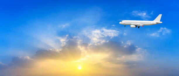 istock Airplane in the sky at sunrise 1161476966