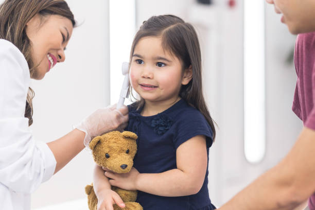 istock Young ethnic girl at the doctor's office getting a checkup 1161477016