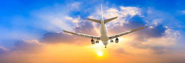 istock Airplane in the sky at sunrise 1161477576