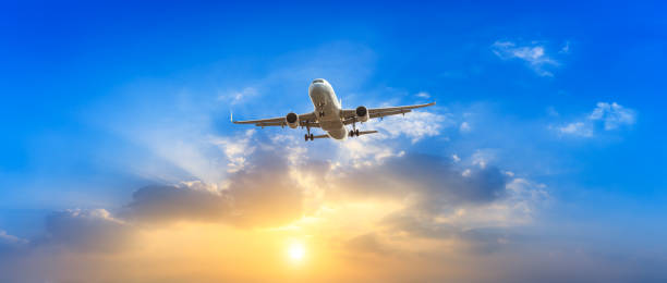 istock Airplane in the sky at sunrise 1161477581