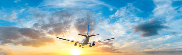 istock Airplane in the sky at sunrise 1161478219