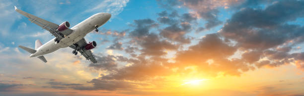 istock Airplane in the sky at sunrise 1161478237