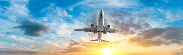 istock Airplane in the sky at sunrise 1161478238