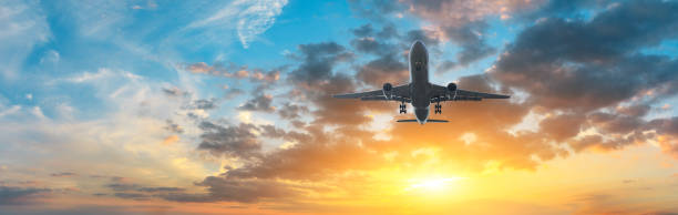 istock Airplane in the sky at sunrise 1161478252
