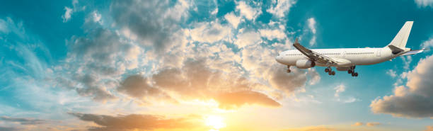 istock Airplane in the sky at sunrise 1161478253