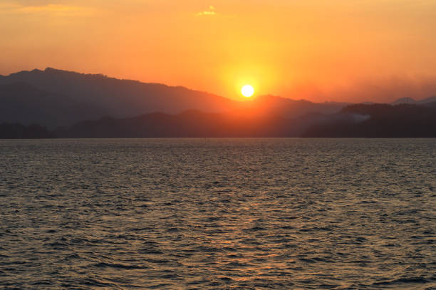 Sunset over the horizon of the Pacific Ocean. Orange sunset over the sea.