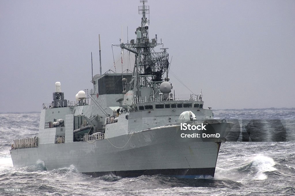 Modern Warship Modern frigate sailing in the rough Atlantic Ocean. Warship Stock Photo
