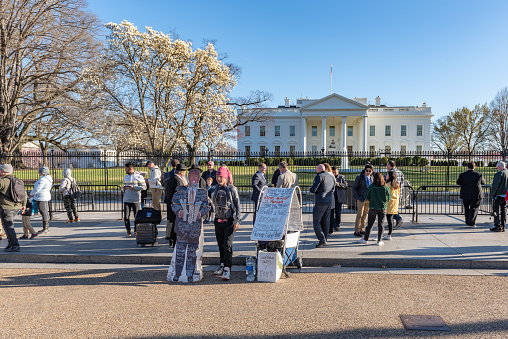 People are visiting White House building exteror in Washington DC,USA.\nAnyone visiting DC can experience the history and art of the White House in person after submitting a tour request through one’s Member of Congress.