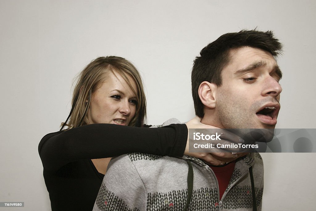 choke! young girl attacking her boyfriend from behind Murder Stock Photo