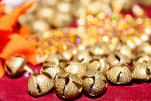 Golden bells of feet anklet of classical Indian dancer with ornaments for Bharatanatyam classical dance in selective focus Indian classical dance background with golden bells of feet anklet and ornaments used by classical Indian female dancer for Bharatanatyam classical dance shot with selective focus bharatanatyam dancing stock pictures, royalty-free photos & images