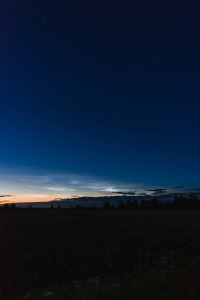 istock Noctilucent clouds on a summer night above p. Glowing clouds in the night sky. 1161501598
