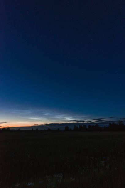 istock Noctilucent clouds on a summer night above p. Glowing clouds in the night sky. 1161501599