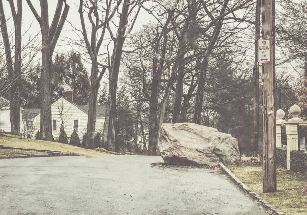 Suburban Humor: No Parking: Between a Rock and a Hard Place Surprising road condition. Accompanying “No Parking” sign seems superfluous under the circumstances. bronxville photos stock pictures, royalty-free photos & images