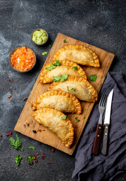 istock Latin American fried empanadas with tomato and avocado sauces. Top view 1161515674