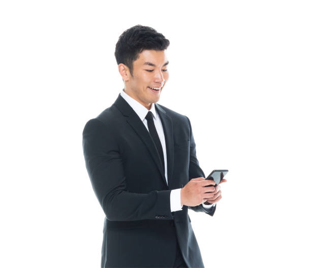 istock Attractive Asian businessman on white background - texting on phone 1161517019