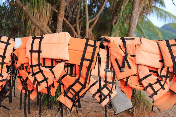 istock Orange color life jackets hanging in the row 1161517037