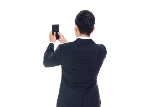 istock Attractive Asian businessman on white background - texting on phone 1161517044