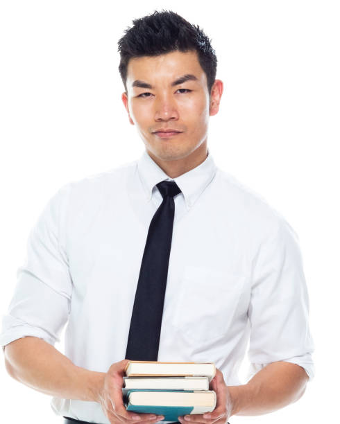istock Handsome Asian Businessman - is holding books 1161517121