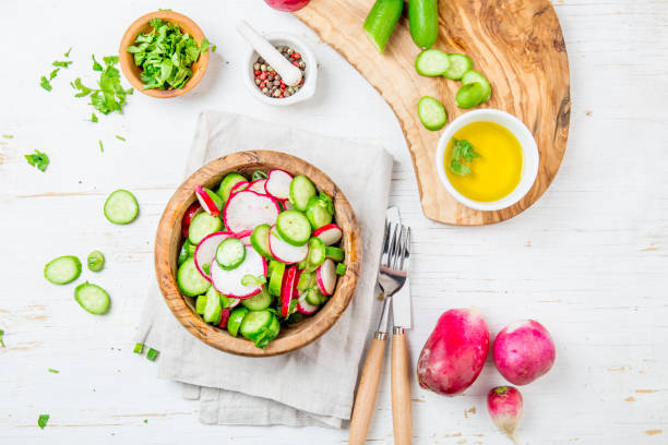 Fresh radish cucumber salad, white background. Top view
