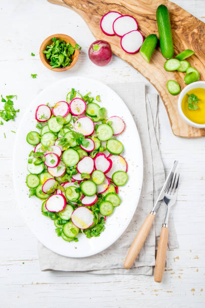 istock Fresh radish cucumber salad, white background. Top view 1161518985