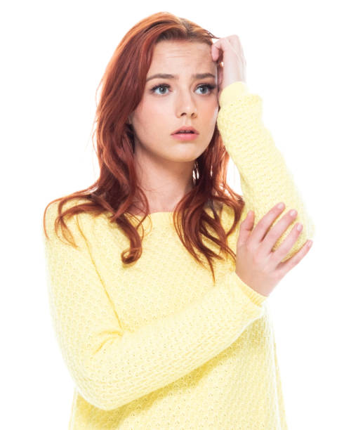istock Cute young female wearing a yellow sweater and light blue jeans 1161521876