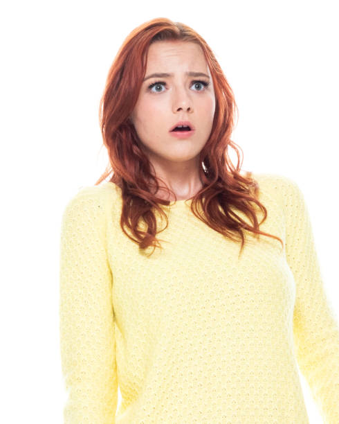 istock Cute young female wearing a yellow sweater and light blue jeans 1161521886