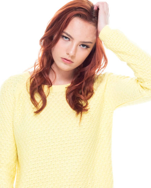 istock Cute young female wearing a yellow sweater and light blue jeans 1161522018