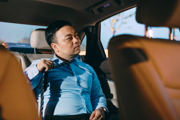 istock Asian businessman sorting a tie and meditating in the car. 1161523262