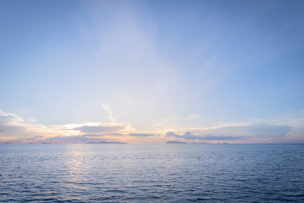 istock Beautiful beach sunset with blue sea and golden light sky  cloud background 1161523813