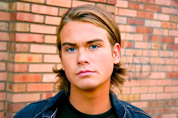 Portrait 20s Male Against Brick Wall