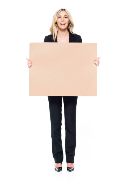 istock Attractive blond businesswoman - holding one placard, looking at camera 1161529862