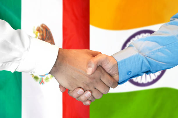 istock handshake on Mexico and India flag background. 1161530407