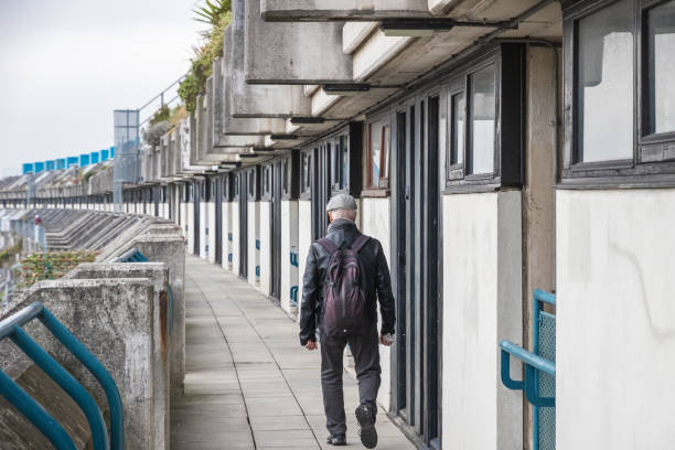 An unidentified man walking on the crescent walkway of Alexandra Road estate in London An unidentified man walking on the crescent walkway of Alexandra Road estate in London, UK council flat stock pictures, royalty-free photos & images