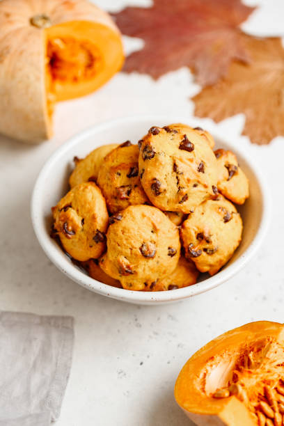 istock Pumpkin cookies with chocolate chips made from cake mix in a white ceramic bowl. 1161533563