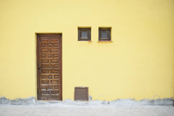 istock Brown door and yellow wall. 1161533789