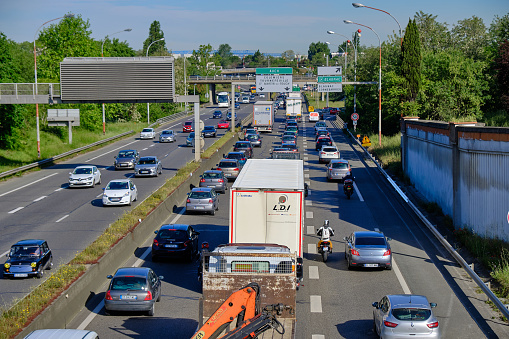 Toulouse, France, May 16, 2019: Heavy car and truck traffic on highway exiting the city