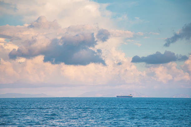istock Cargo ship on horizon, clear sky, wide shot 1161534642