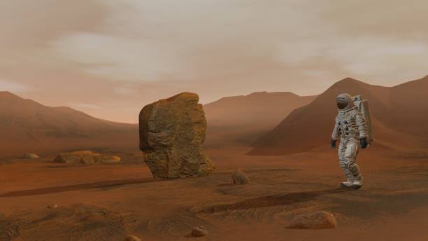 istock 3D rendering. Colony on Mars. Two Astronauts Wearing Space Suit Walking On The Surface Of Mars. 1161536999