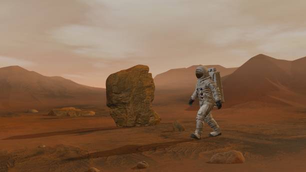 istock 3D rendering. Colony on Mars. Two Astronauts Wearing Space Suit Walking On The Surface Of Mars. 1161537180