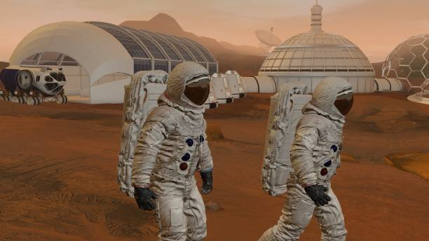 istock 3D rendering. Colony on Mars. Two Astronauts Wearing Space Suit Walking On The Surface Of Mars. 1161537658