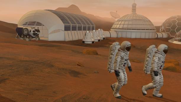 istock 3D rendering. Colony on Mars. Two Astronauts Wearing Space Suit Walking On The Surface Of Mars. 1161537693