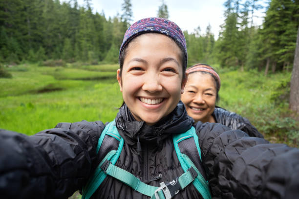 Daughter and Mother Taking Selfie While Hiking Along Alpine Lake Mt. Seymour Provincial Park, North Vancouver, British Columbia, Canada bc photos stock pictures, royalty-free photos & images