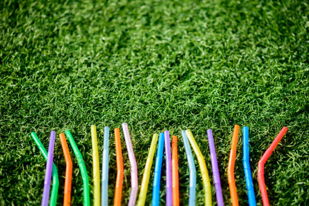 istock Colorful drinking straw with green grass background 1161537990