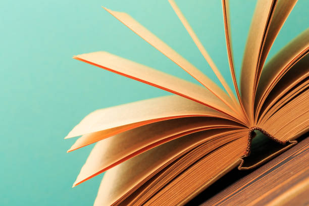 istock Open book on wooden vintage table blue background - Image 1161538821