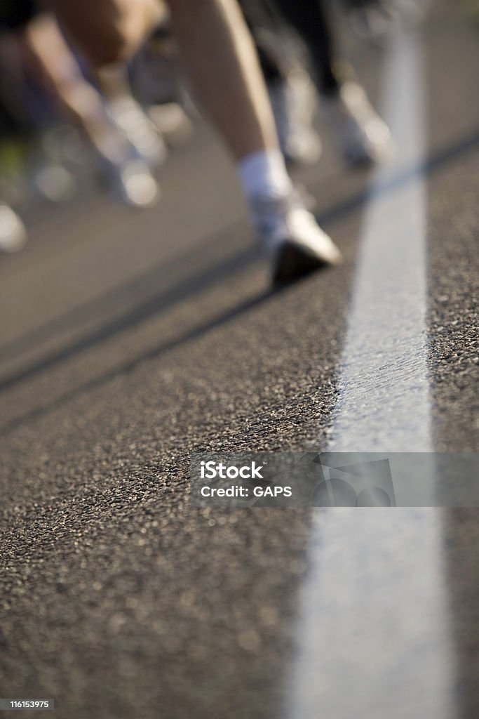 runners on an asphalt road Asphalt Stock Photo