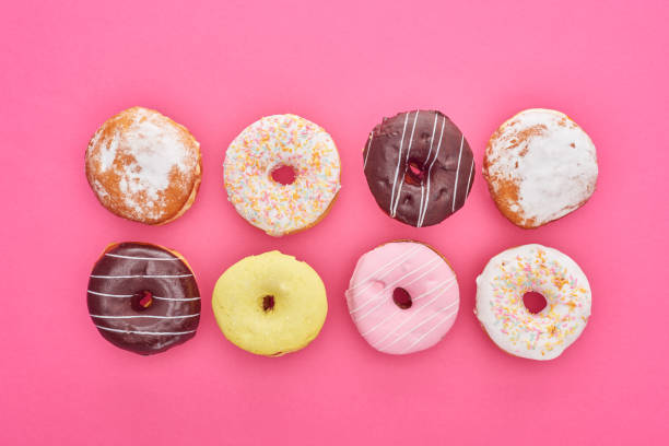 istock top view of tasty glazed doughnuts on bright pink background 1161540670