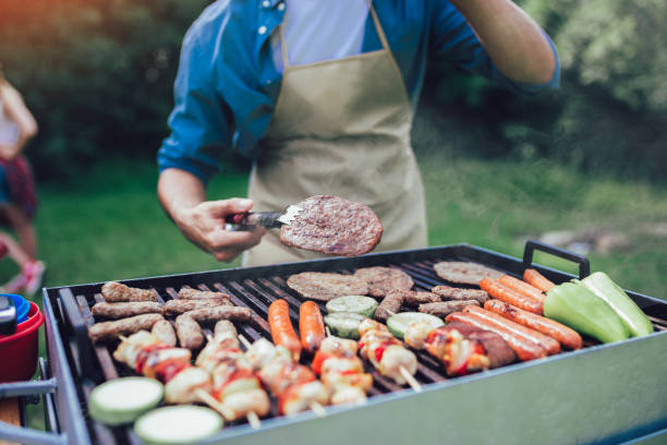 istock Handsome male preparing barbecue outdoors for friends 1161543227