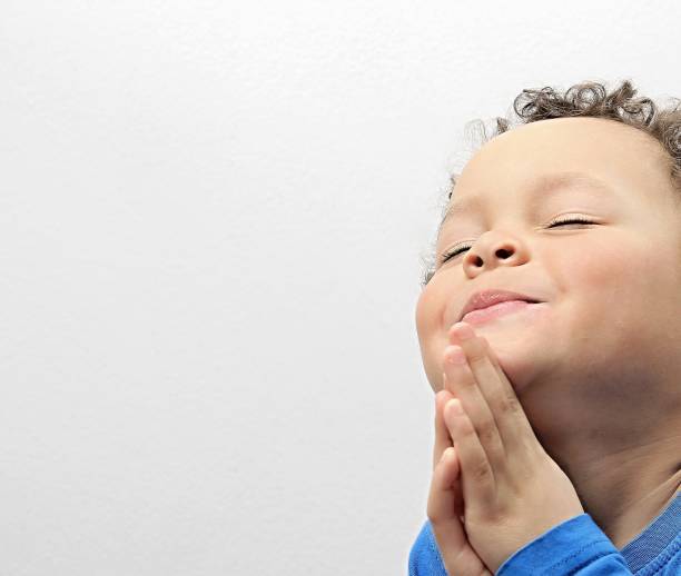 istock little boy praying to God 1161543290